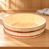 I-654-60 wooden sushi rice tub with two copper-colored bands shown empty on a wooden preparation counter