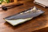 IM211-WK brown and white porcelain rectangular sushi plate on a wooden restaurant table