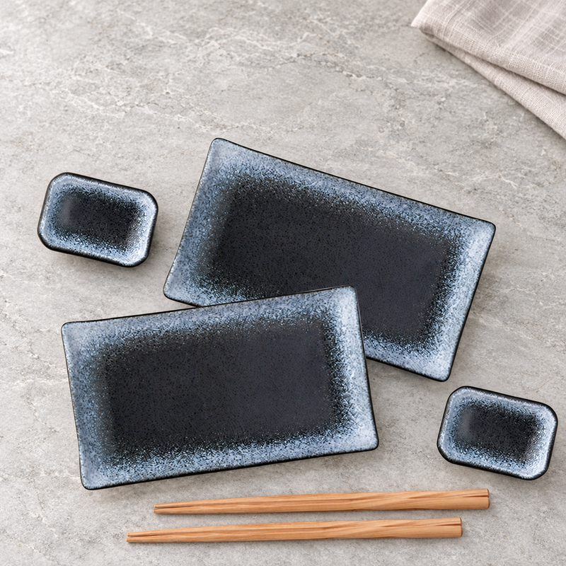 Two JX79-2 navy-and-blue ceramic place settings on a dining table