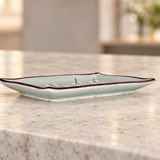 JX79-BP-P individual Blue Plum plate, low side-profile view on a pale stone counter