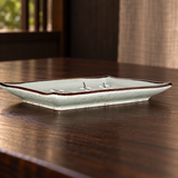 JX79-BP-P individual Blue Plum plate, low side-profile view on a wooden restaurant table