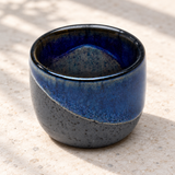 JX8-2 blue diagonal-glaze sake cup on a pale stone counter