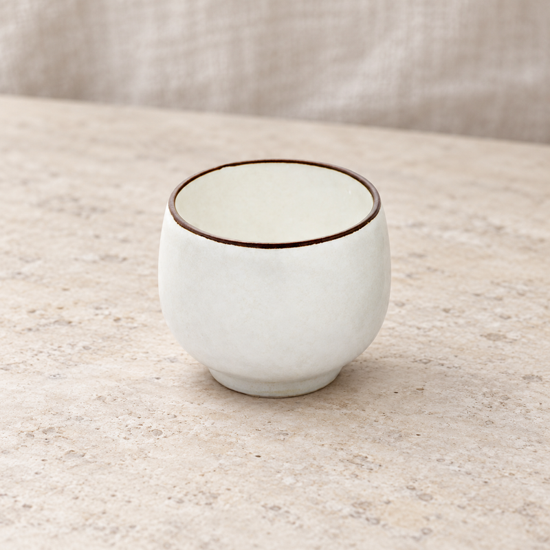 K30-PE white ceramic sake cup on a restaurant table