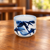 KA8-BB blue bamboo sake cup on a wooden restaurant table