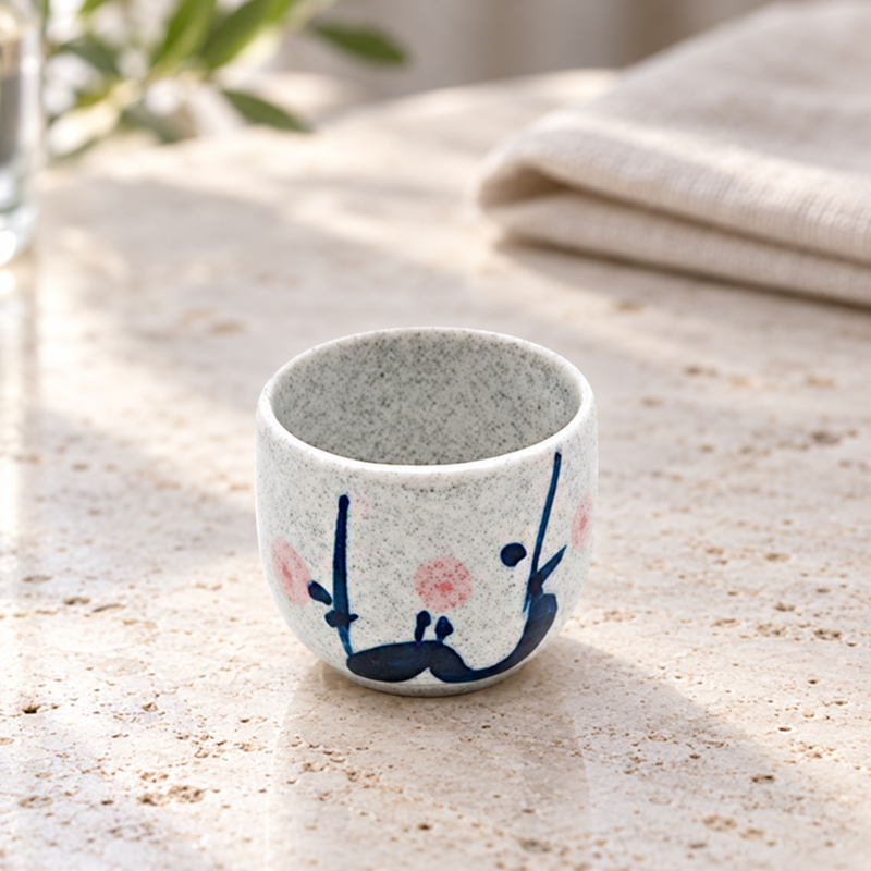 KY8-WS floral ceramic sake cup on a wooden table