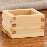 OMS-102 wooden square sake cup on a restaurant table