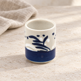 SH8-1 white and blue sake cup on a pale tabletop with linen