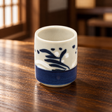 SH8-1 white and blue sake cup on a wooden restaurant table