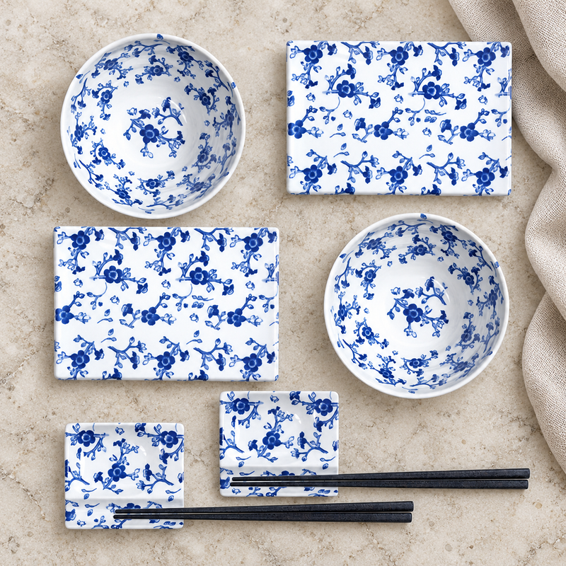 Two SU1-PU blue-and-white floral place settings on a stone table