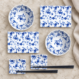 SU1-PU blue floral set with two plates, two bowls, two dishes and two chopstick pairs on pale stone
