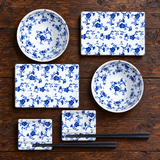 SU1-PU blue floral set with two plates, two bowls, two dishes and two chopstick pairs on wood