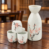 TSS1-731 pink blossom sake set, one bottle and four cups, on a wooden restaurant table