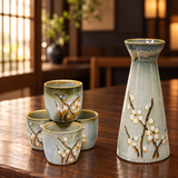 TSS83 gray blossom sake set with one bottle and four cups on a wooden restaurant table