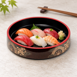 WO-17-4 black sushi oke with red rim and gold wheel pattern with nigiri on a stone table