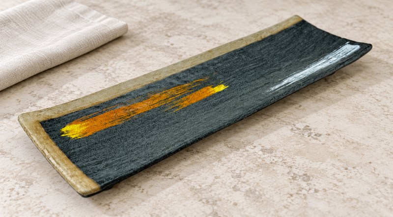 YG-5014BP dark rectangular plate with orange and white brush accents on a table
