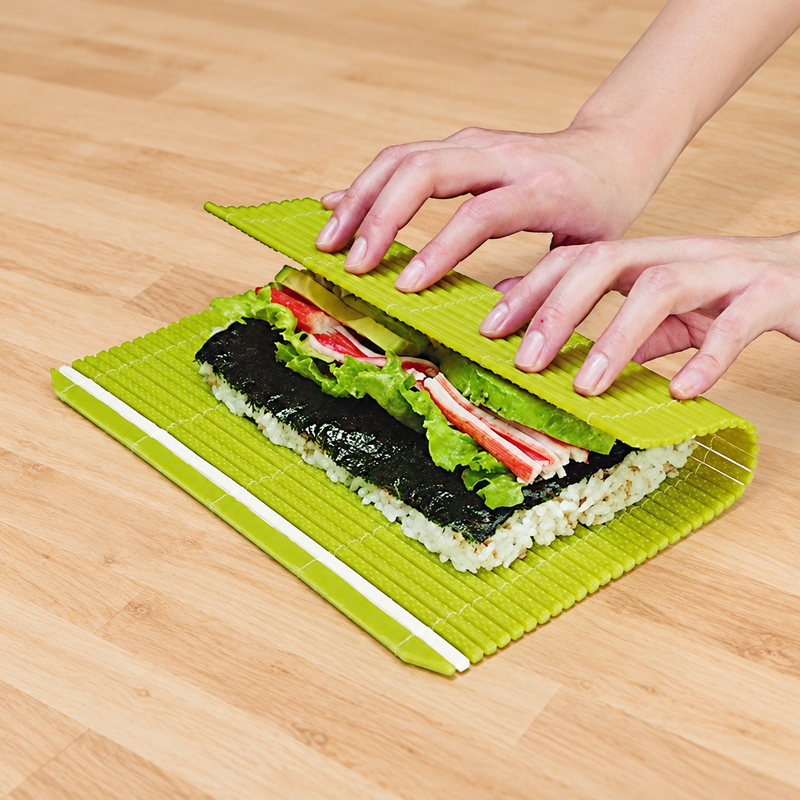 Green FMK-MG plastic sushi mat used for rolling at a preparation counter