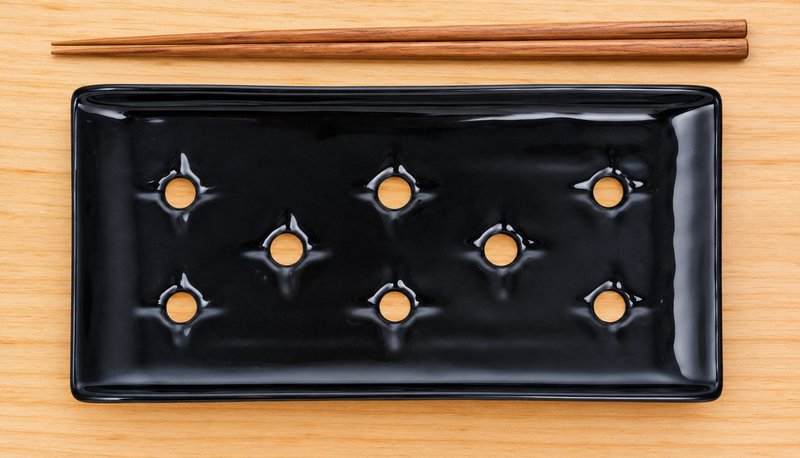 Black KM5924-B porcelain case plate on a preparation counter