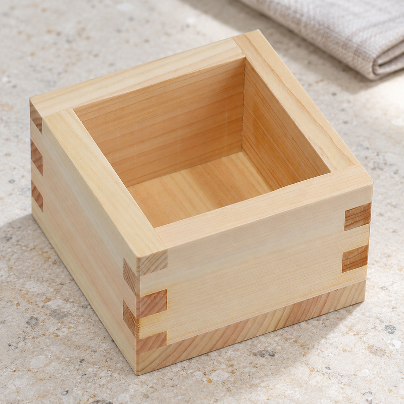 Elevated view of the square OMS-100 wood masu on a stone table