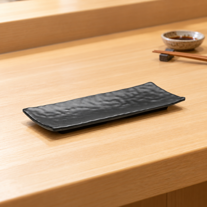YG-5311MB textured black rectangular plate on a wooden restaurant counter