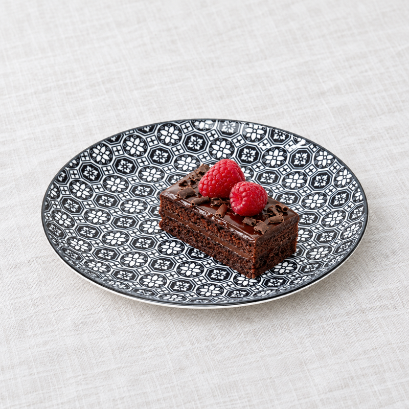 TN281-BK black geometric floral plate with a small chocolate cake