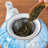 Loose tea added to the blue blossom teapot's mesh infuser