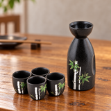 TSS1-300 black bamboo sake set with one bottle and four cups on a wooden table
