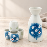 TSS73 blue floral sake set with one bottle and four cups, on a pale stone counter