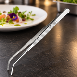TTG-8C curved stainless-steel plating tongs in a dark prep-station setting