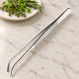 TTG-8C curved stainless-steel plating tongs in a light prep-station setting