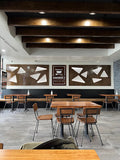 Walnut solid ashwood seat and back restaurant chair with metal frame; restaurant setting with other furniture illustrative