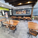 Walnut solid ashwood seat and back restaurant chair with metal frame; restaurant setting with other furniture illustrative