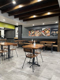 Walnut solid ashwood seat and back restaurant chair with metal frame; restaurant setting with other furniture illustrative