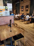 White oak butcher block tabletops in natural finish in restaurant setting; bases and other furniture not included; dimensions vary by size