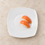 White rounded-square ceramic plate with salmon nigiri
