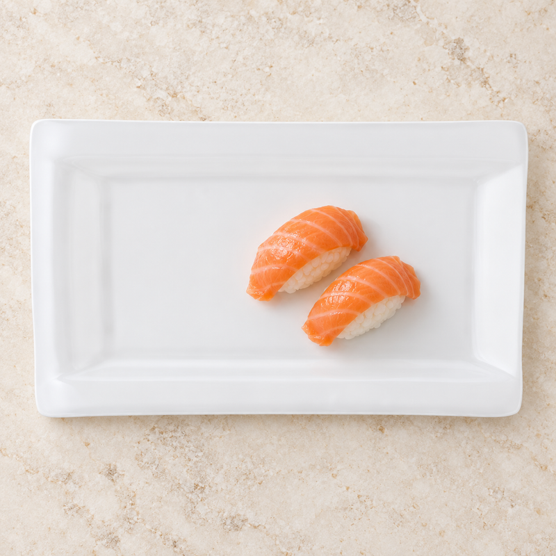 White rectangular ceramic platter with salmon nigiri