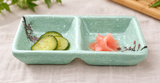 Mint-green floral two-compartment sauce dish with cucumber pickles and ginger
