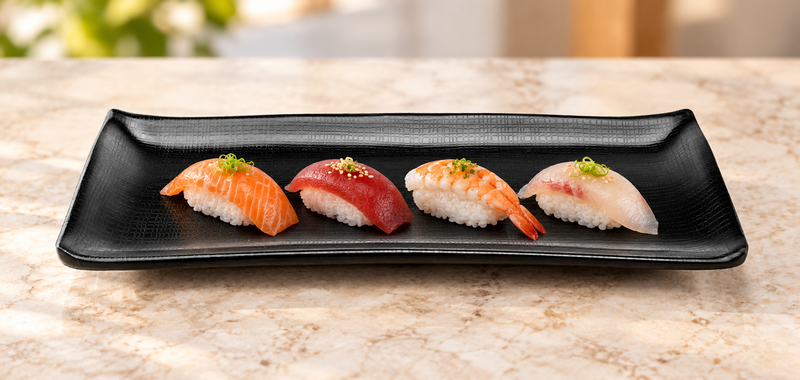 Matte-black textured rectangular platter with four nigiri