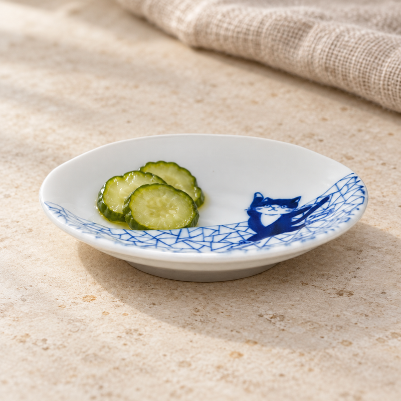 4″ Blue & White Ceramic Skating Cat Sauce Dish, 2 oz — with three cucumber slices