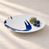 YG25-CL blue crab claw plate with green mochi and blueberries on linen