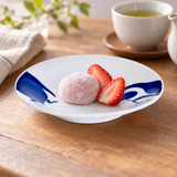 Blue penguin ceramic plate with a small mochi and strawberries