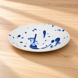 Blue cat-design ceramic plate on a wood tabletop