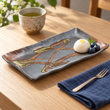 YK212-WS brushwork ceramic plate with a petite mochi and blueberries beside tea and a dessert fork