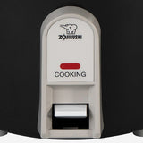 Close-up of the black Zojirushi NHS-06BA cooking switch and red Cooking indicator; this model has no Keep Warm control.