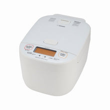 Zojirushi NW-YNC18 White pressure induction-heating rice cooker in a front three-quarter view with orange LCD controls and hinged lid.