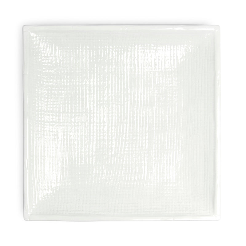 Overhead view of the A1130 white square plate showing fine crosshatched relief and gently upturned edges.