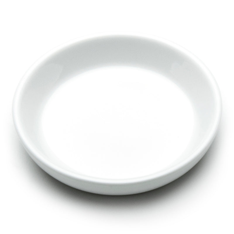 Plain white A1887 sauce dish viewed from above at an angle, showing its shallow round well and low rim.