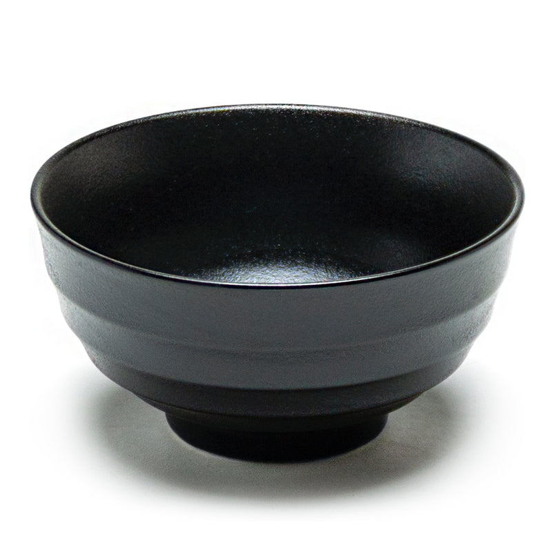 Deep matte-black porcelain bowl with horizontal exterior bands and a short ring foot.