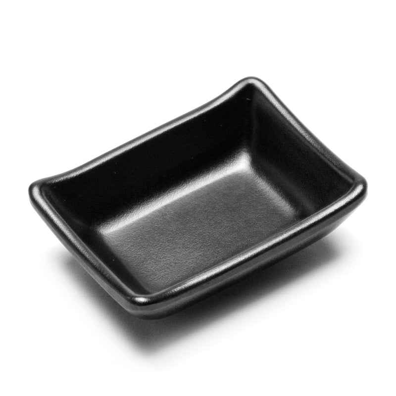 Matte black rectangular sauce dish showing its raised sides and upturned corners.