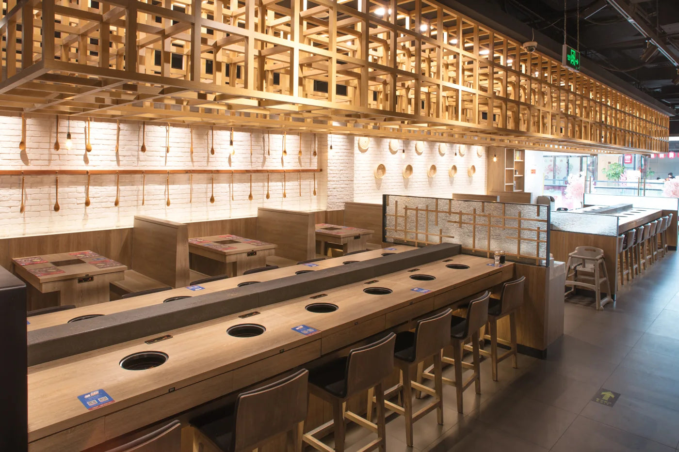 Counter and booth dining with inset hot-pot cooking positions