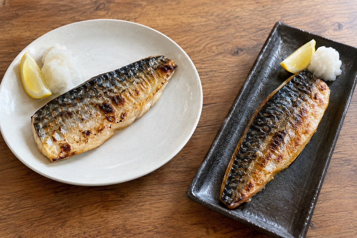 Two equivalent grilled fish portions served on round and long rectangular plates